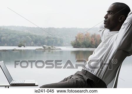 Stock Photography - A businessman thinking. Fotosearch
