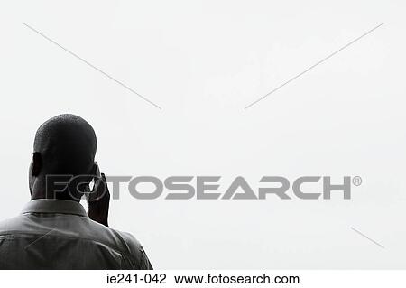 A businessman using a cell phone View Large Photo Image Stock Image - A businessman using a cell phone. Fotosearch