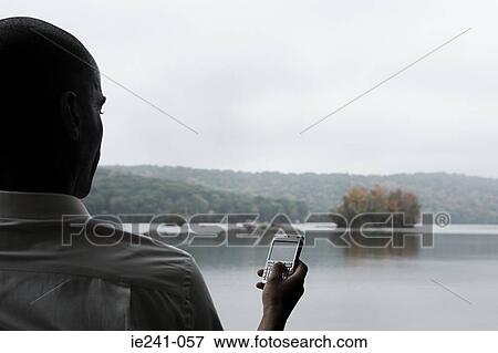 A businessman using a cell phone View Large Photo Image Stock Photo - A businessman using a cell phone. Fotosearch