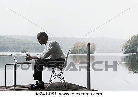 A businessman using a laptop View Large Photo Image Stock Image - A businessman using a laptop. Fotosearch