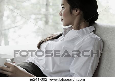 Stock Image - A businesswoman thinking. Fotosearch