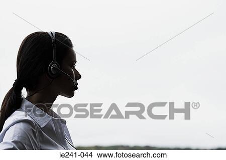 Picture -  A businesswoman wearing a headset. Fotosearch
