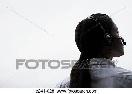 A businesswoman wearing a headset View Large Photo Image Stock Photo - A businesswoman wearing a headset. Fotosearch
