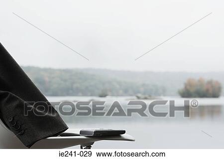 A jacket and a cell phone on a chair View Large Photo Image Stock Photo - A jacket and a cell phone on a chair. Fotosearch
