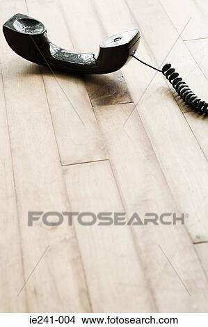 A telephone on a wooden floor View Large Photo Image Picture - A telephone on a wooden floor. Fotosearch