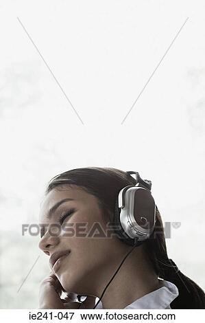 Stock Photo - Businesswoman listening to music. Fotosearch