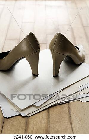 Stock Image - High heeled shoes on top of files. Fotosearch