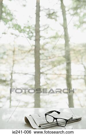 Stock Photograph - Newspaper and glasses. Fotosearch