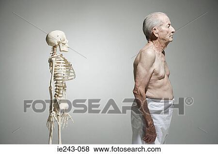 Elderly man standing near a skeleton View Large Photo Image Stock Photo - Elderly man standing near a skeleton. Fotosearch