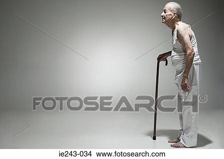 Elderly man with a walking stick View Large Photo Image Picture - Elderly man with a walking stick. Fotosearch