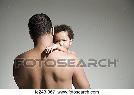 Father holding his son View Large Photo Image Stock Photo - Father holding his son. Fotosearch