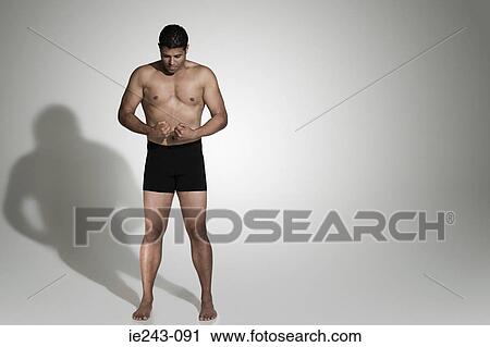 Stock Image - Man flexing his muscles. Fotosearch
