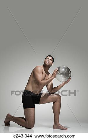 Picture - Man holding a globe. Fotosearch