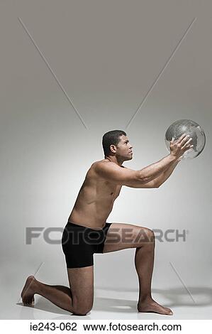 Man holding a globe View Large Photo Image Stock Image - Man holding a globe. Fotosearch