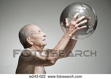 Senior man holding a globe View Large Photo Image Stock Image - Senior man holding a globe. Fotosearch