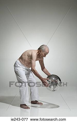 Senior man holding a globe View Large Photo Image Stock Photo - Senior man holding a globe. Fotosearch