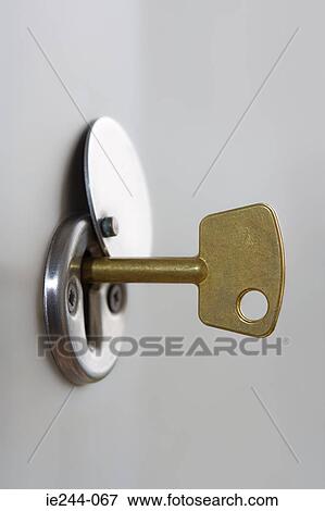A key in a lock View Large Photo Image Stock Photo - A key in a lock. Fotosearch