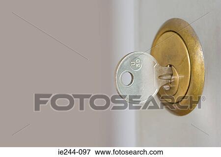 A key in a lock View Large Photo Image Stock Photo - A key in a lock. Fotosearch