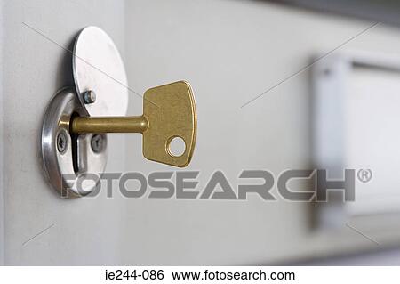 A key in a lock View Large Photo Image Stock Photograph - A key in a lock. Fotosearch