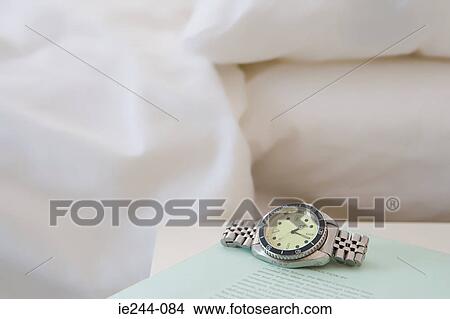 A watch on a book View Large Photo Image Picture - A watch on a book. Fotosearch