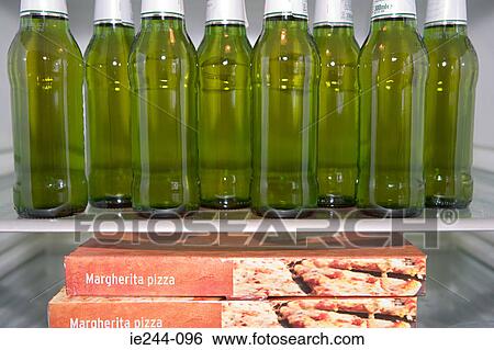 Bottles of beer and pizza in a fridge View Large Photo Image Stock Photograph - Bottles of beer and pizza in a fridge. Fotosearch