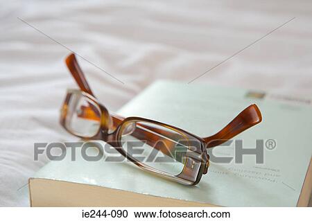 Glasses on a book View Large Photo Image Stock Image - Glasses on a book. Fotosearch