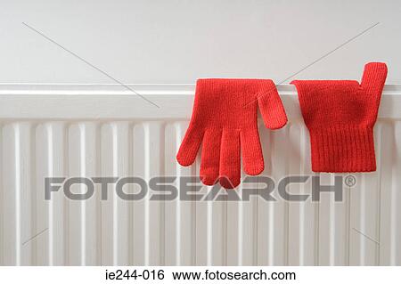 Gloves drying on a radiator View Large Photo Image Stock Photograph - Gloves drying on a radiator. Fotosearch