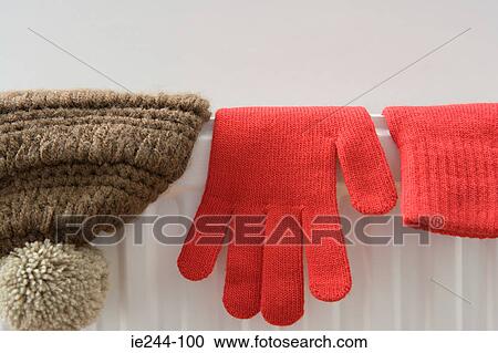 Hat and gloves drying on a radiator View Large Photo Image Stock Image - Hat and gloves drying on a radiator. Fotosearch