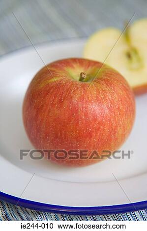 Red apple on a plate View Large Photo Image Stock Image - Red apple on a plate. Fotosearch