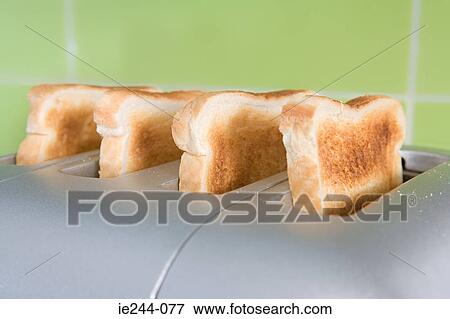 Stock Photo - Toast in a toaster. Fotosearch