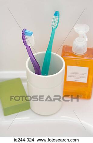 Toothbrush cup and soap on a sink View Large Photo Image Picture - Toothbrush cup and soap on a sink. Fotosearch
