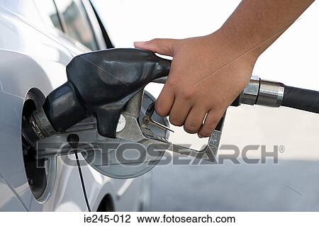 Stock Image - A person filling a petrol tank. Fotosearch