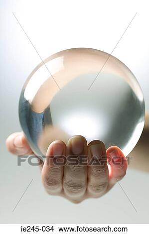 A person holding a crystal ball View Large Photo Image Picture - A person holding a crystal ball. Fotosearch