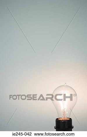An illuminated lightbulb View Large Photo Image Stock Image - An illuminated lightbulb. Fotosearch