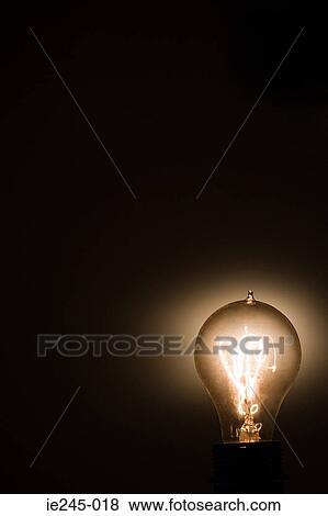 An illuminated lightbulb View Large Photo Image Stock Photo - An illuminated lightbulb. Fotosearch
