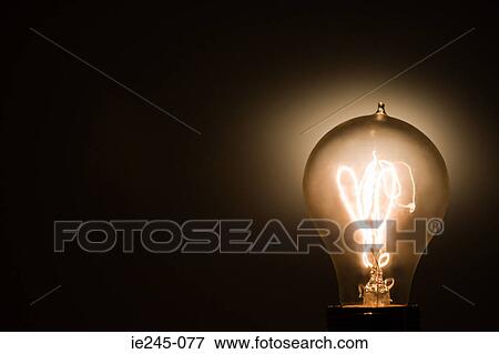 An illuminated lightbulb View Large Photo Image Stock Photo - An illuminated lightbulb. Fotosearch