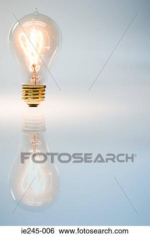 An illuminated lightbulb View Large Photo Image Stock Photograph - An illuminated lightbulb. Fotosearch