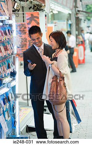 A couple shopping for cell phones View Large Photo Image Stock Image - A couple shopping for cell phones. Fotosearch