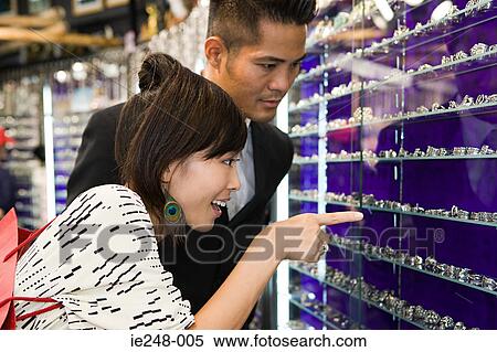 A man and woman looking at jewelry View Large Photo Image Stock Photography - A man and woman looking at jewelry. Fotosearch