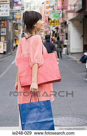 Stock Photo - A young woman shopping. Fotosearch