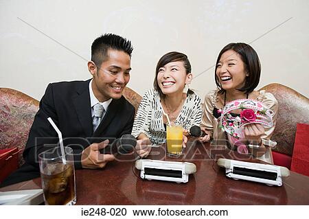 Friends doing karaoke View Large Photo Image Stock Image - Friends doing karaoke. Fotosearch