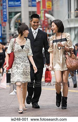 Stock Image - Friends shopping in tokyo. Fotosearch