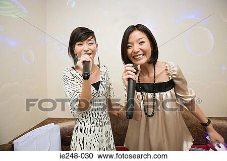 Friends singing karaoke View Large Photo Image Stock Image - Friends singing karaoke. Fotosearch