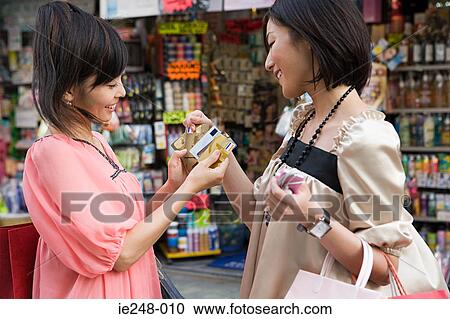 Two friends holding credit cards View Large Photo Image Stock Image - Two friends holding credit cards. Fotosearch