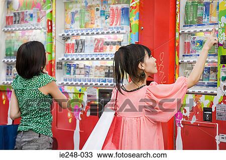 Young women choosing drinks from a vending machine View Large Photo Image Stock Image - Young women choosing drinks from a vending machine. Fotosearch