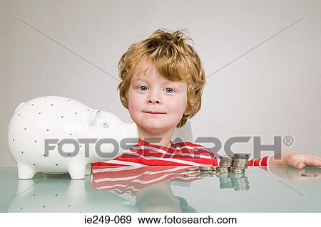 Boy with piggy bank View Large Photo Image Stock Photo - Boy with piggy bank. Fotosearch