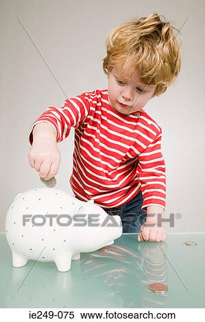 Stock Photography - Boy with piggy bank. Fotosearch