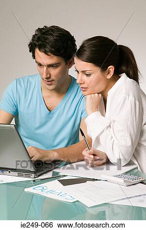 Couple arranging finances View Large Photo Image Stock Photograph - Couple arranging finances. Fotosearch