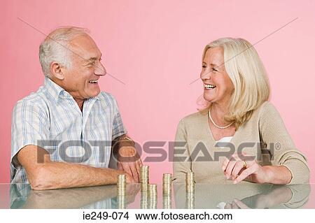 Couple with coins View Large Photo Image Picture - Couple with coins. Fotosearch