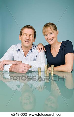Couple with coins View Large Photo Image Stock Image - Couple with coins. Fotosearch